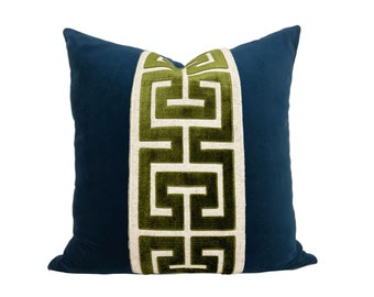May include: A blue pillow with a green and white geometric pattern down the center.