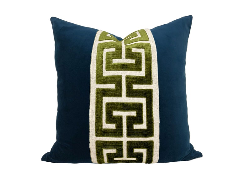 May include: A blue pillow with a green and white geometric pattern down the center.
