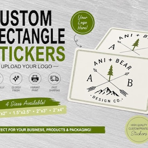May include: Custom rectangle stickers with a white background and a black and green logo featuring the text ANI + BEAR DESIGN CO, a pine tree, arrows, and mountains. The stickers are individually cut with a glossy finish in 1x2, 1.5x2.5, 2x3, and 2x4 inch sizes.