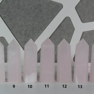 May include: Eight pink crystal towers of varying heights, numbered 8 through 14.