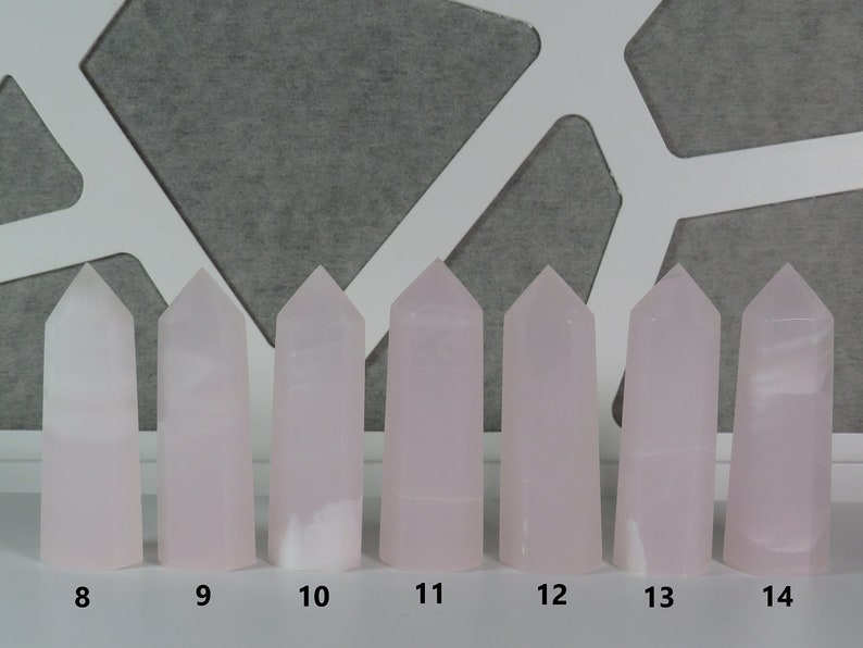 May include: Eight pink crystal towers of varying heights, numbered 8 through 14.