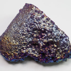 May include: A large, iridescent, purple and gold, agate geode with a rough, textured surface. The geode has a unique, bubbly appearance.