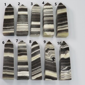 May include: Ten black and white striped obsidian crystal points, numbered 1 through 10.