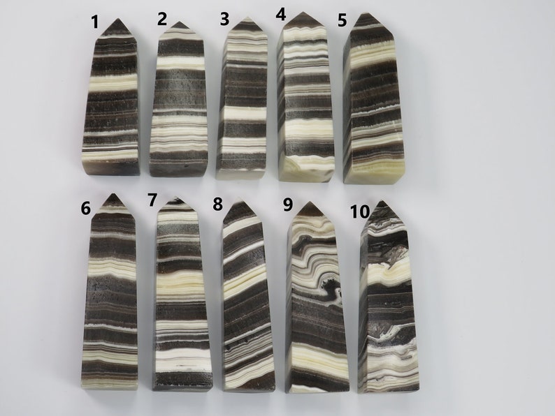 May include: Ten black and white striped obsidian crystal points, numbered 1 through 10.