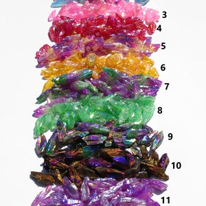 May include: Eleven rows of iridescent crystal chips in various colours, including blue, pink, red, yellow, green, brown, and purple. The chips are arranged in rows, with each row numbered 1 through 11.