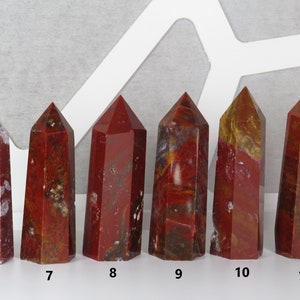 May include: Six red, brown, and white jasper crystal points, arranged in a row from left to right, numbered 6 through 11.