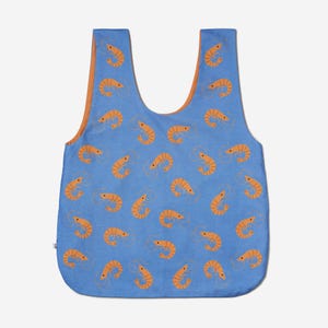 May include: A blue tote bag with an orange shrimp pattern. The bag has a contrasting orange interior and a simple, open design. The shrimp are stylized and repeated across the bag's surface.