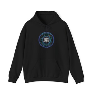 May include: Black hooded sweatshirt with a front pocket and drawstring. The sweatshirt features a circular graphic with the text "CALM UNDER ZERO PRESSURE" in white and blue, surrounded by a blue and green design.