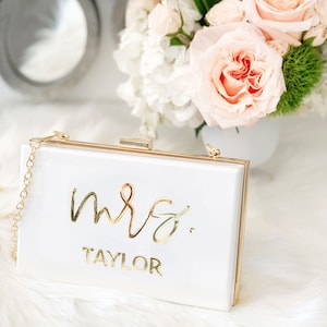 White purse with custom name "mrs. Taylor" in gold text