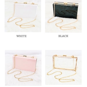 White, black, pink and clear purse