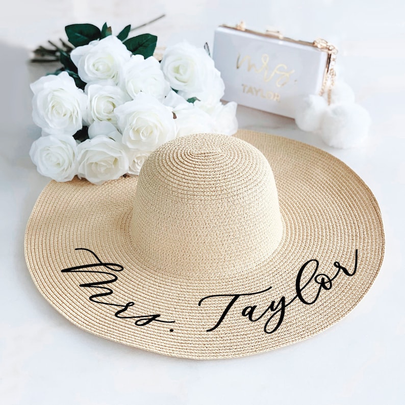 Tan sun hat with black vinyl text