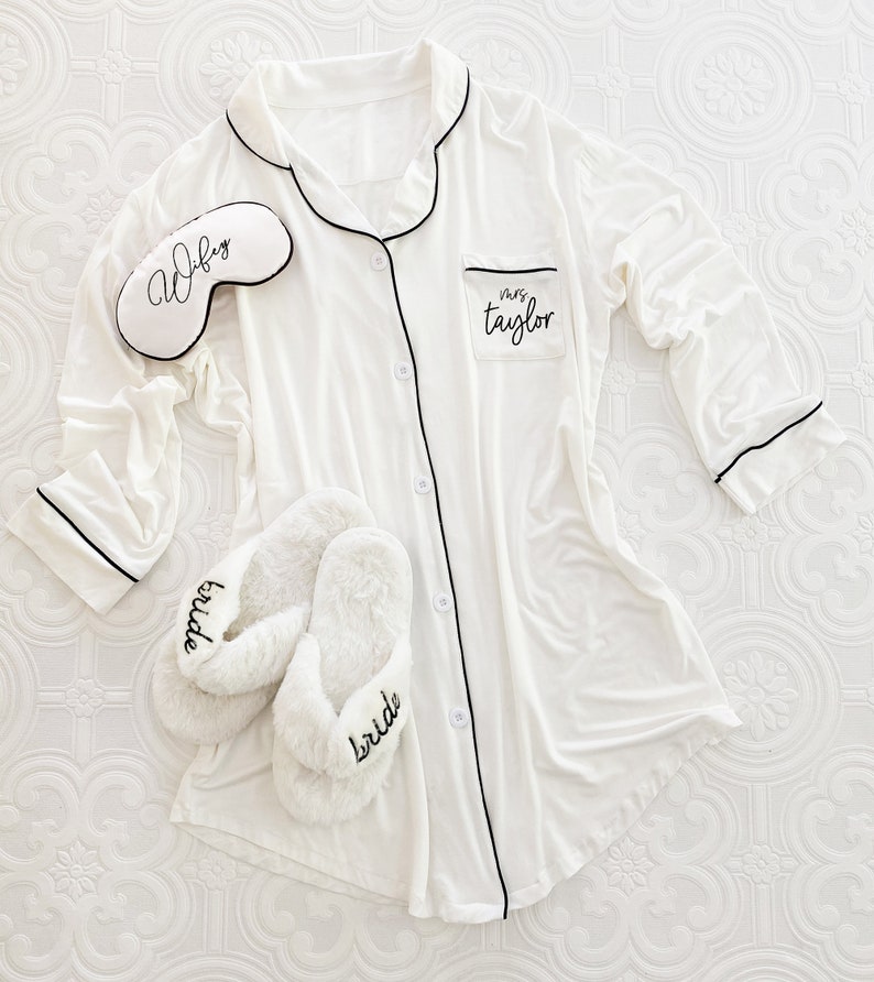 A white sleep shirt with slippers and a white eyelash designed sleep mask