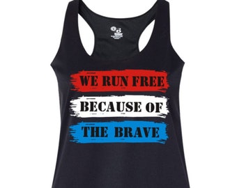 May include: Black tank top with a red, white, and blue design. The text "WE RUN FREE BECAUSE OF THE BRAVE" is printed on the front of the tank top.