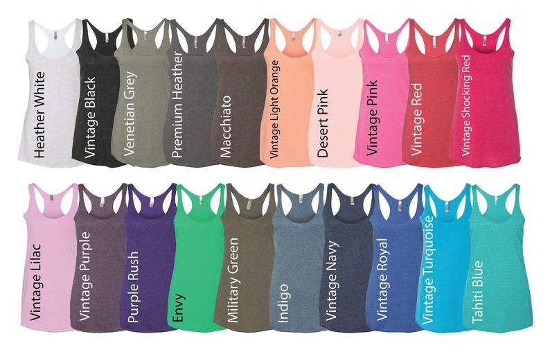 May include: A variety of tank tops in different colors, including heather white, vintage black, Venetian grey, premium heather, macchiato, vintage light orange, desert pink, vintage pink, vintage red, vintage shocking red, vintage lilac, vintage purple, purple rush, envy, military green, indigo, vintage navy, vintage royal, vintage turquoise, and Tahiti blue.