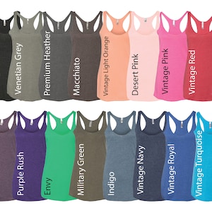 May include: A variety of tank tops in different colors, including heather white, vintage black, Venetian grey, premium heather, macchiato, vintage light orange, desert pink, vintage pink, vintage red, vintage shocking red, vintage lilac, vintage purple, purple rush, envy, military green, indigo, vintage navy, vintage royal, vintage turquoise, and Tahiti blue.
