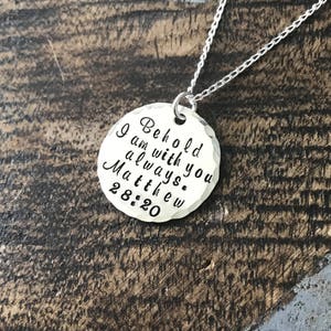 May include: Silver necklace with a round pendant that reads "Behold I am with you always. Matthew 28:20".