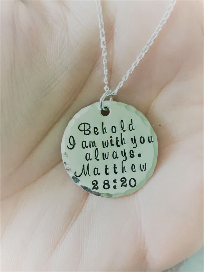 May include: Silver necklace with a round pendant that says "Behold I am with you always. Matthew 28:20".