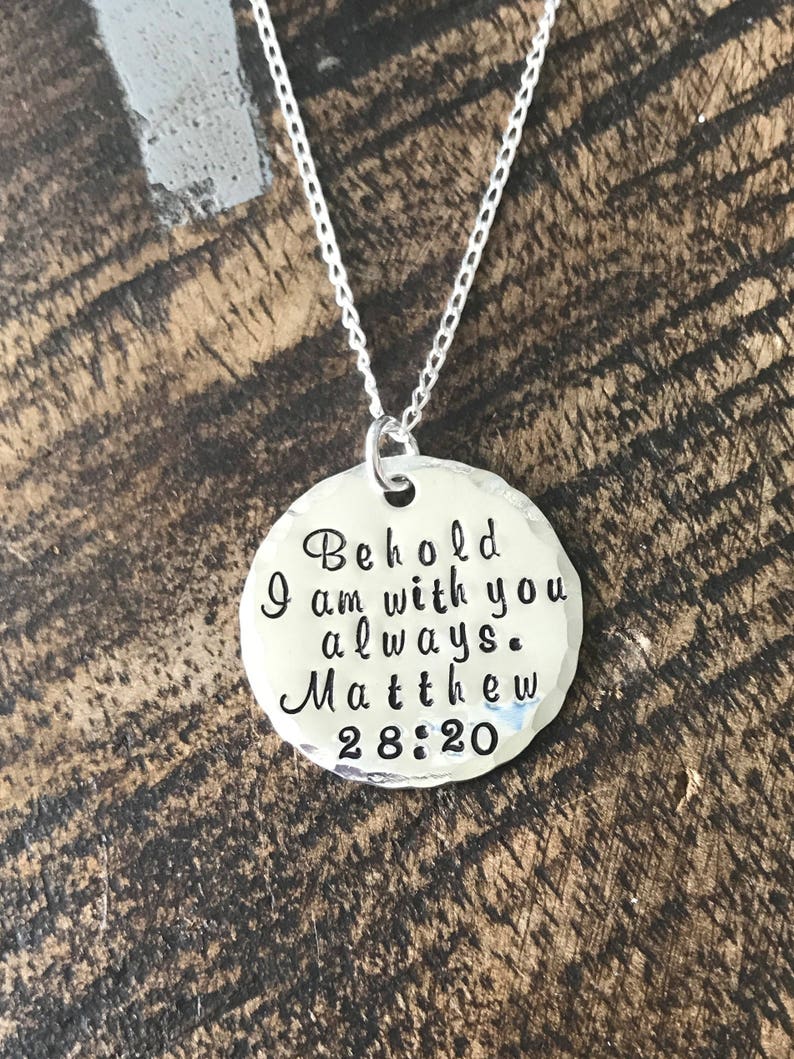 May include: Silver necklace with a round pendant that says "Behold I am with you always. Matthew 28:20"