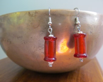 Red glass barrel drop earrings with silver accents.