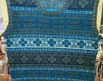A one of a kind Round neck hand knit fair isle sleeveless pullover in shades of blue and green.