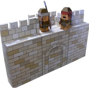 May include: A papercraft model of a fortress wall with two cartoon soldiers. The wall is made of light beige bricks, with a rounded archway. One soldier holds a spear and shield, the other has a mustache and red headband. The figures are brown and tan.