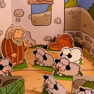 May include: A cartoon illustration of a man with a beard and a brown robe standing in front of a stone wall. He is surrounded by white sheep with black eyes and hooves. The scene is set in a cartoon village with a brown wooden door and a window with stars.
