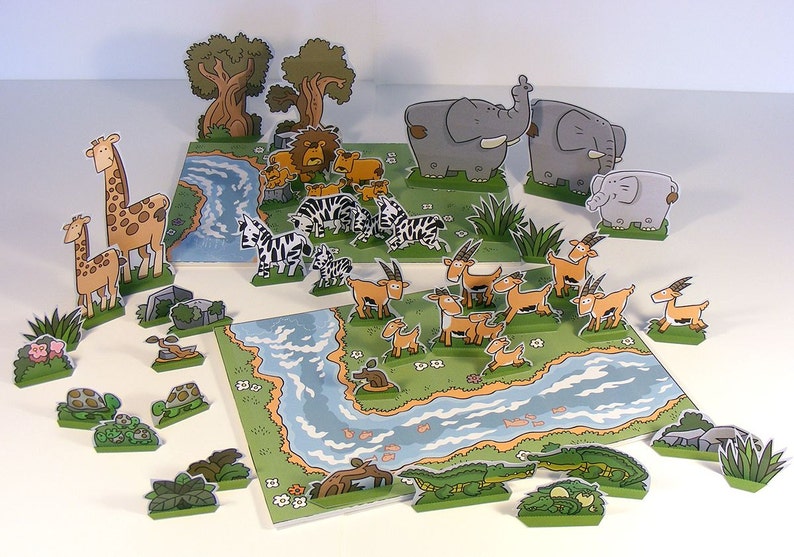 May include: A colorful paper craft set featuring a variety of animals, including giraffes, zebras, elephants, and gazelles. The set also includes trees, rocks, and a river.