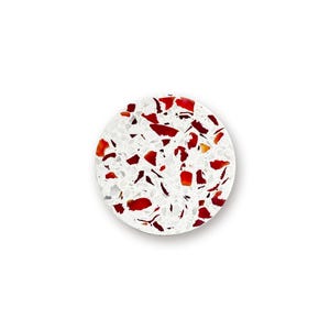 May include: A circular coaster featuring a white base embedded with numerous irregular, scattered red and dark red fragments. The surface has a speckled, terrazzo-like appearance with a smooth finish, creating a high-contrast pattern of white and red.