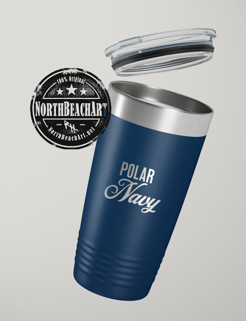May include: A stainless steel tumbler with a navy blue exterior and a silver lid. The tumbler has a white inscription that reads "POLAR NAVY".