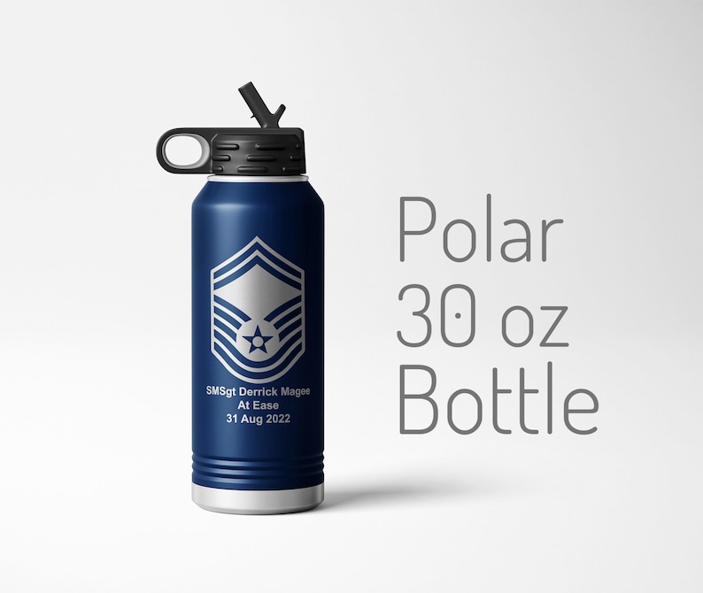 May include: A blue 30 ounce stainless steel water bottle with a black lid and a carrying handle. The bottle has a silver emblem of the Air Force rank of Senior Master Sergeant and the text "SMSgt Derrick Magee At Ease 31 Aug 2022".