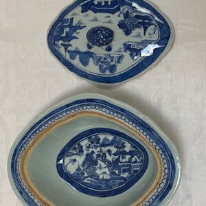 May include: A blue and white porcelain oval serving dish with a lid. The dish has a blue and white floral design with a border of blue and white dots. The lid has a similar design with a knob in the center.