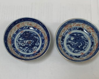 Un par de porcelana china antigua azul blanco con cuencos de salsa roja diseñados Dragon Buena Suerte