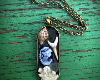 Lost at Sea Cameo Brass Necklace with Shark Tooth, Coral, Lady Cameo, Shell, and Coral