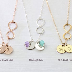 May include: Three infinity symbol necklaces with personalized charms. The necklaces are available in rose gold filled, sterling silver, and 14k gold filled.