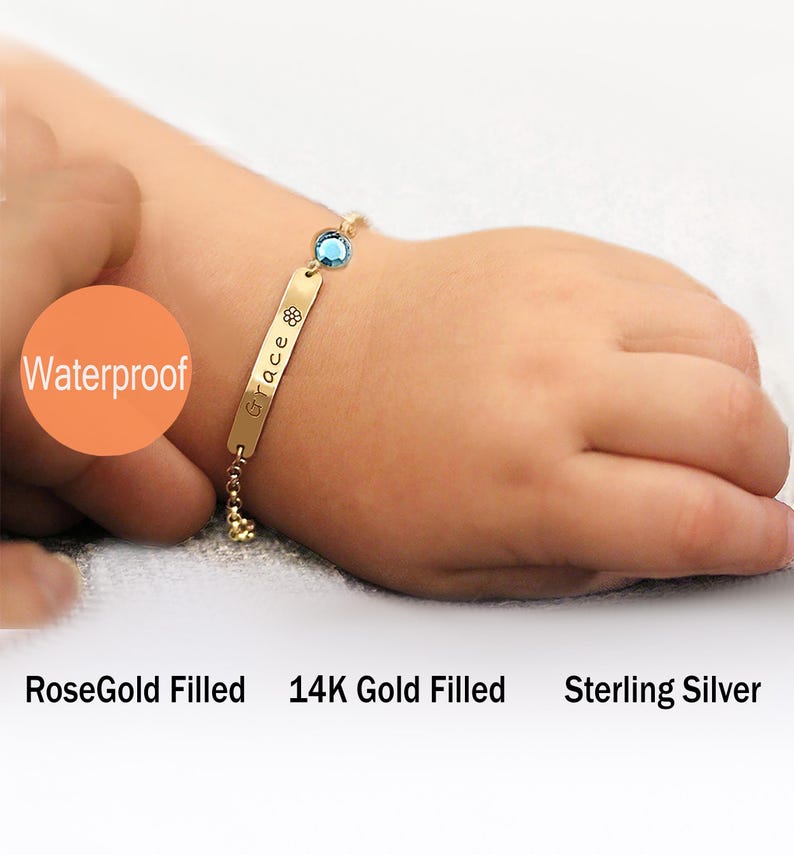 May include: A gold bracelet with a blue gemstone and a personalised nameplate that reads "Grace". The bracelet is waterproof and available in rose gold filled, 14k gold filled, and sterling silver.