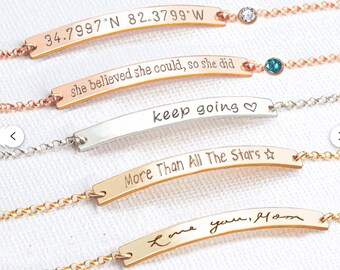 May include: Five delicate chain bracelets with curved metal bars. The bars feature engravings: 34.7997 N 82.3799 W, she believed she could, so she did, keep going with a heart, More Than All The Stars with a star, and Love you, Mom. Two have small crystals.