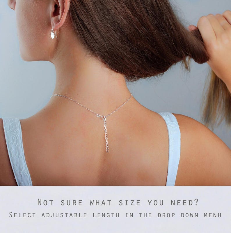 May include: A silver chain necklace featuring an adjustable extender link section at the back. The necklace is worn around the neck, with the silver chain and extender clearly visible. Text below reads: NOT SURE WHAT SIZE YOU NEED? SELECT ADJUSTABLE LENGTH IN THE DROP DOWN MENU.