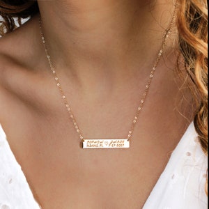 May include: Gold chain necklace with a personalized bar pendant engraved with "Sophia Jason Miami, FL 7-17-2017".