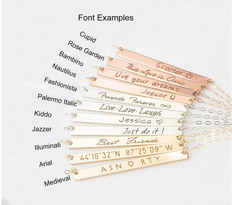 May include: A close-up of ten silver and gold bar necklaces with different engraved text, including "Scooter", "This Love is Ours", "Live your dreams", "Jaguar U", "Friends Forever", "Live Love Laugh", "Jessica", "Just do it!", "Best Friends", "44&deg;16&prime;32&Prime;N 87&deg;25&prime;09&Prime; W", and "ASNORTY".