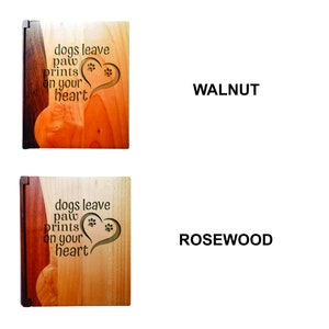 May include: Wooden pet memorial plaques with the text "dogs leave paw prints on your heart." One plaque is walnut, the other is rosewood. Each plaque features a heart with paw prints.