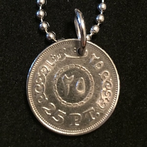 May include: Silver coin pendant necklace with a 25 PT inscription and Arabic script. The coin features a central design with the number "10" in Arabic numerals.