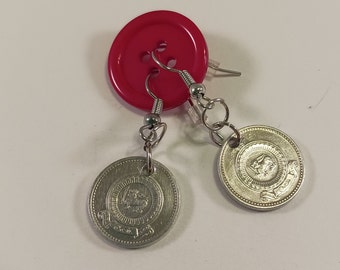 May include: A pair of earrings made from silver-toned coins with a design featuring a lion and the words "One Dollar" and "Year of the Lion". The earrings are hanging from a red button.