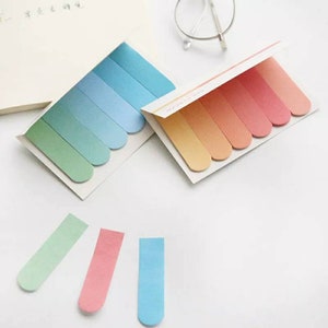 May include: Two sets of colorful sticky notes with rounded edges. One set has shades of blue and green, the other has shades of orange and yellow. There are also three individual notes in blue, green, and pink.