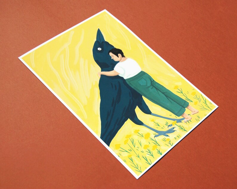 May include: A black bird with a person hugging it from behind. The bird is standing on a yellow field with green grass and yellow flowers. The person is wearing blue jeans and a white shirt.