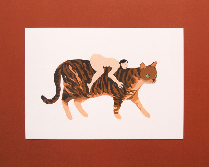 May include: A nude person riding a brown and black tabby cat with green eyes. The cat is walking forward with its head turned to the side.