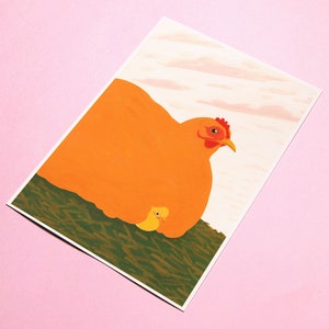 May include: A close-up of a mother hen and her chick. The hen is orange and has a red comb. The chick is yellow and is nestled under the hen's wing. The background is a light pink.