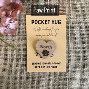 paw print and pets name on wooden heart