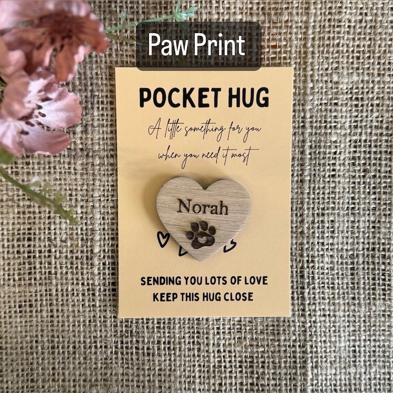 paw print and pets name on wooden heart