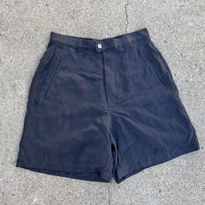 May include: Dark gray high-waisted shorts with a button and zipper closure. The shorts have two front pockets and two back pockets.