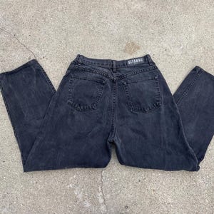 May include: Black denim jeans with a